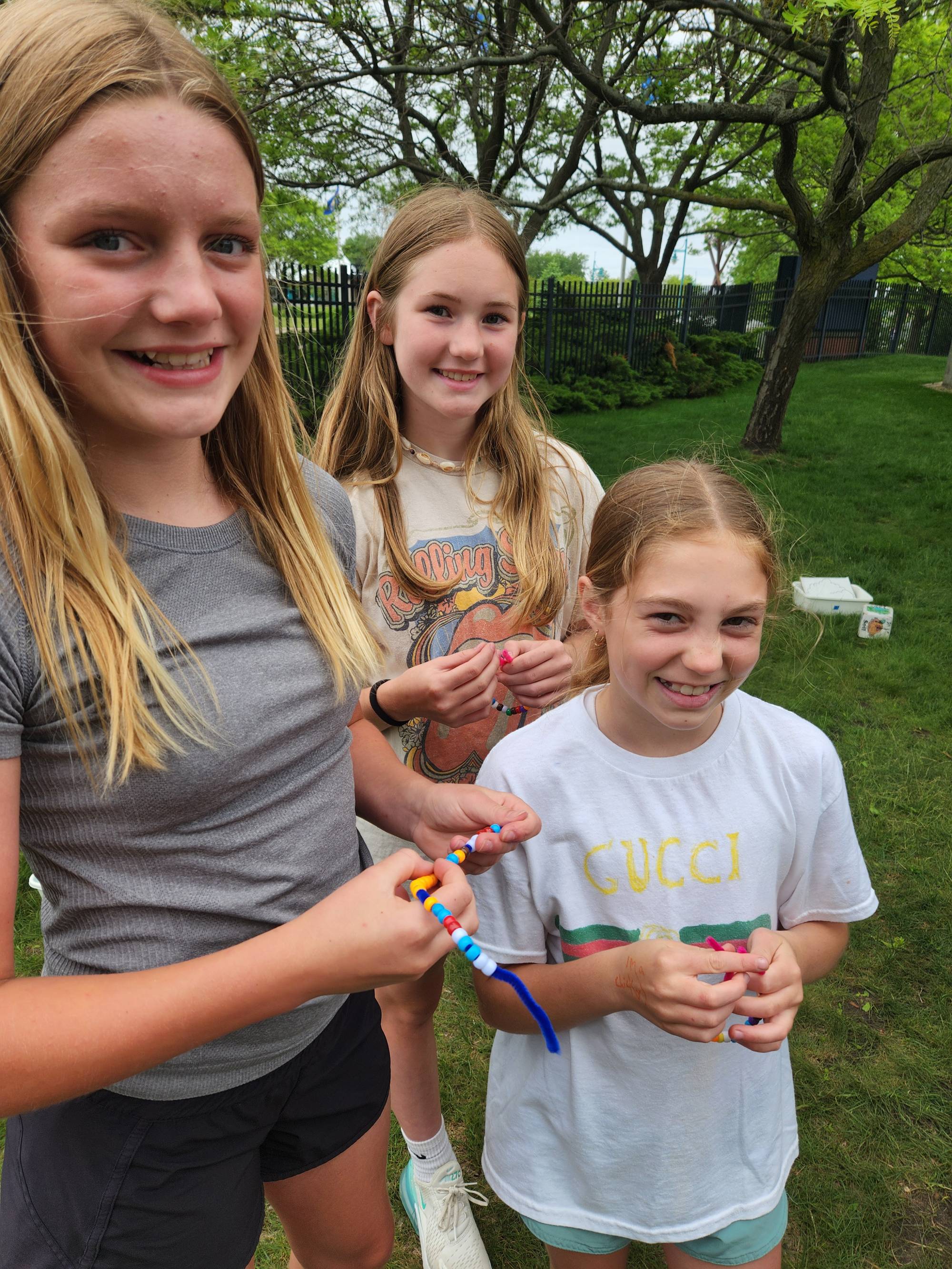Students holding bead bracelets